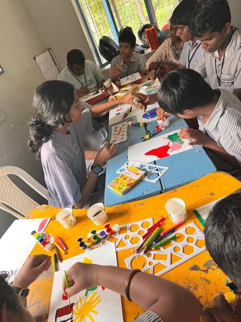Shruti Arvind guiding students as they paint with poster colours and stencils